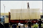 Machinery being loaded on a flat rack container for shipment 